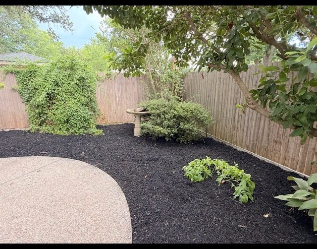 Landscaping mulch bed and fence line clean up
