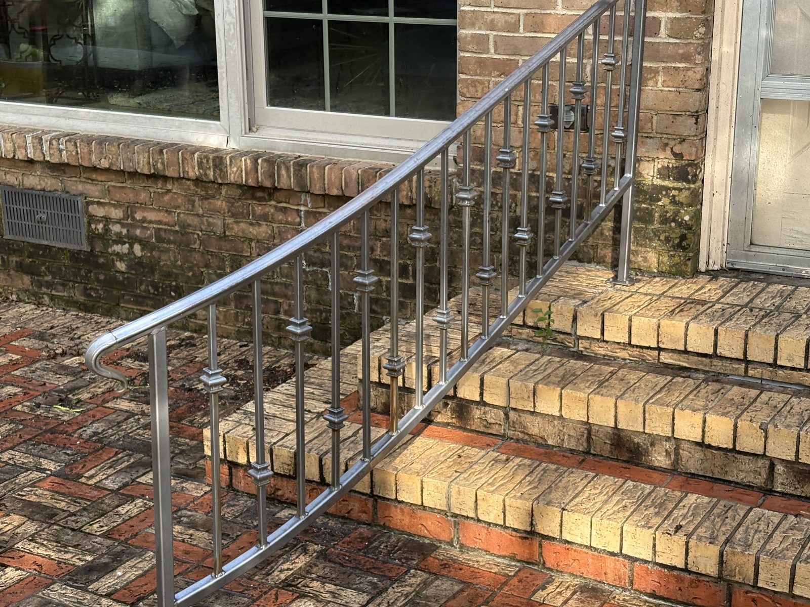 Brick steps and railing with mildew before soft washing