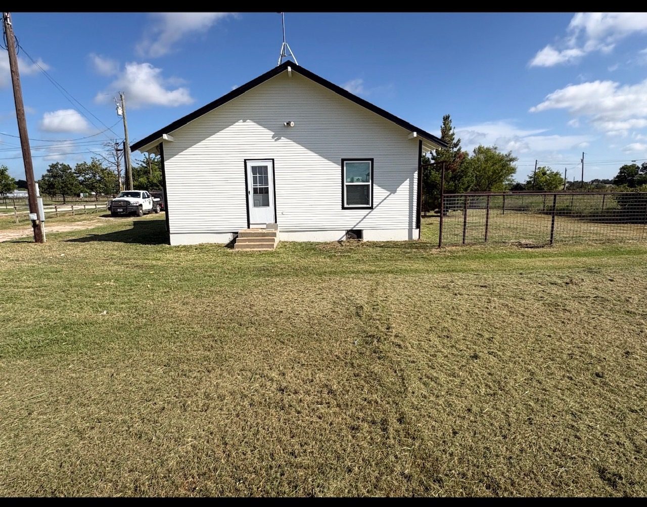 Ranch house yard after mowing, green grass